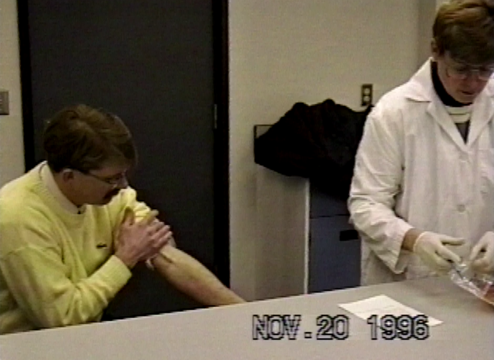 Tube can be seen protruding from left arm