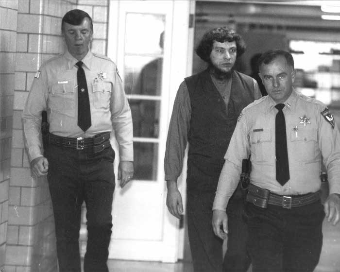 Ed Gingerich escorted by police