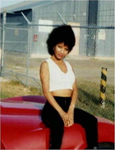 Omaima poses on Bill Nelson’s red Corvette