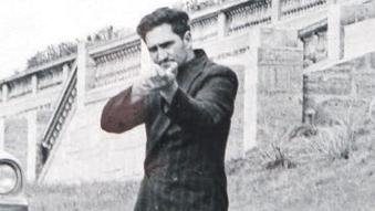 Eric Edgar Cooke with a rifle in a police re-enactment